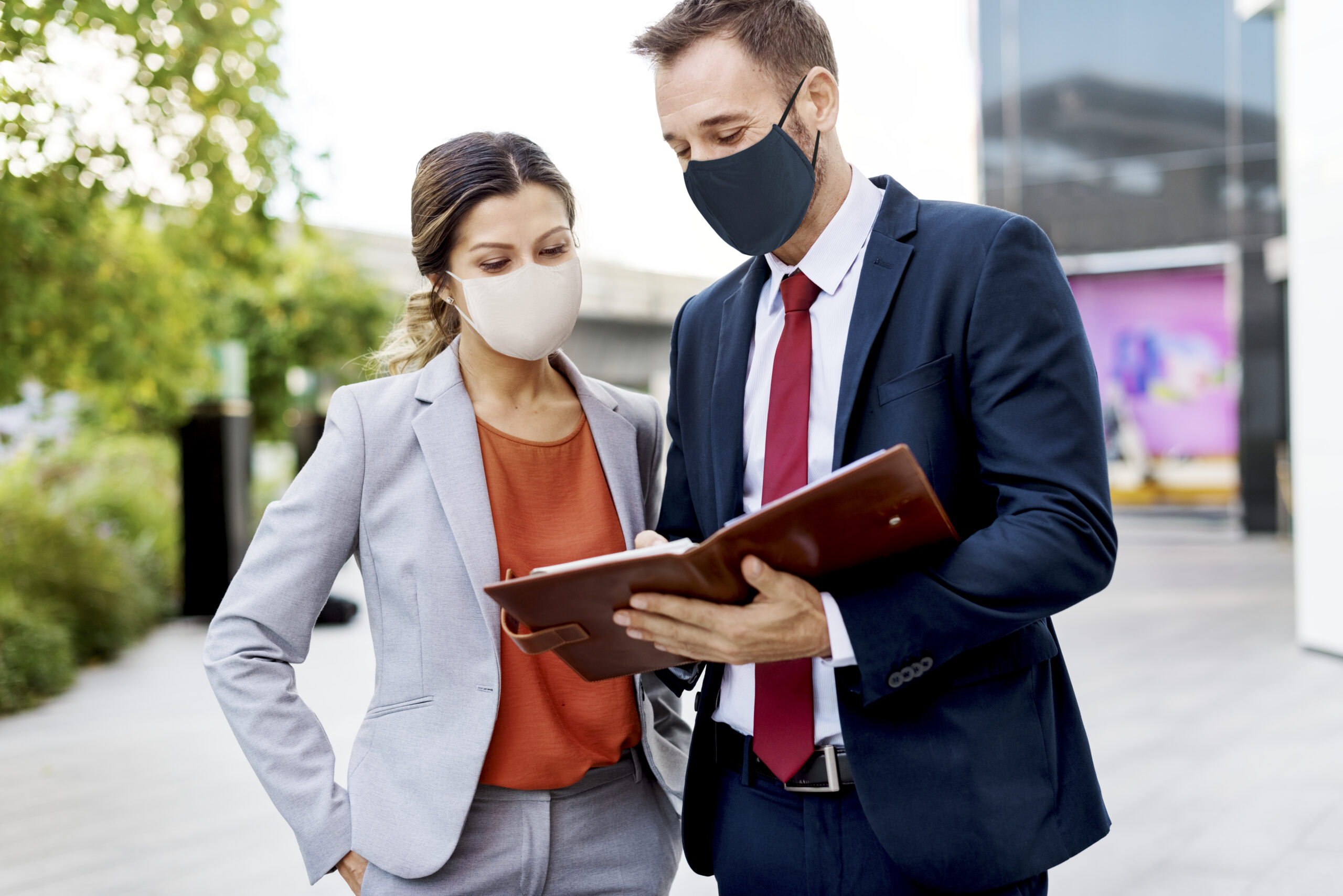 Business people in medical masks discussing work plan during coronavirus pandemic