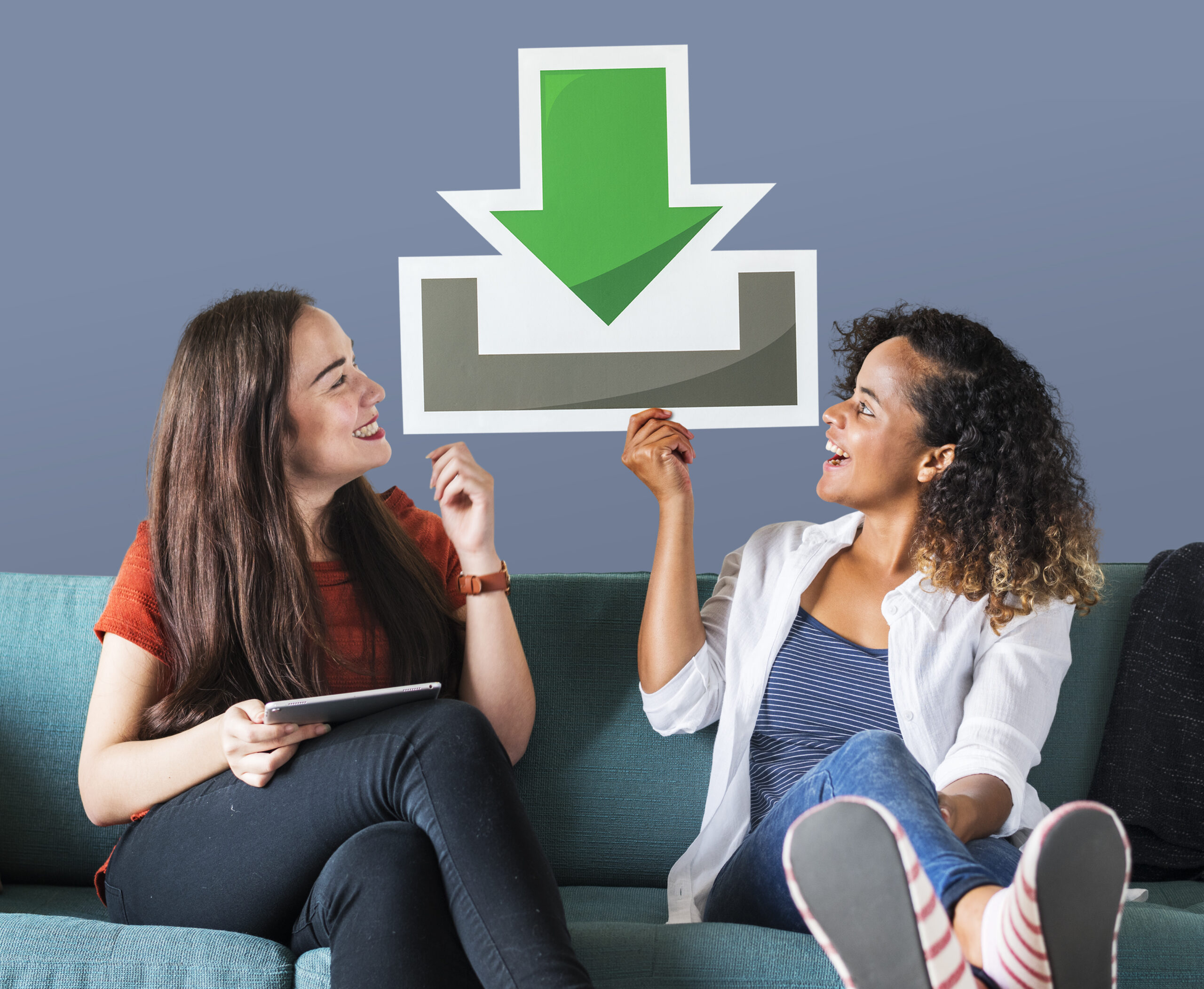 Young female friends holding a download icon